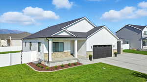 Modern inspired farmhouse featuring board and batten siding, a porch, a gate, and a shingled roof