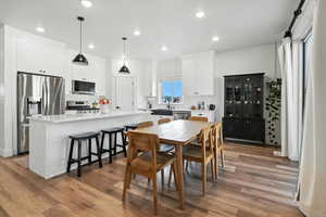 Dining space with light wood-style flooring and recessed lighting