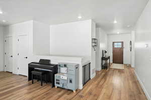 Foyer featuring light wood-style floors and recessed lighting