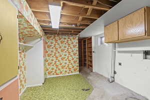 Below grade area featuring wallpapered walls