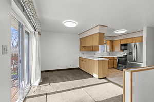 Kitchen featuring light countertops and stainless steel appliances