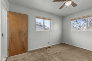 Unfurnished bedroom featuring carpet flooring and a ceiling fan