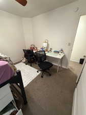 Bedroom featuring carpet floors, a desk, and ceiling fan