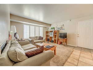 Living room featuring light tile patterned floors and baseboards