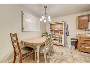 Dining room featuring light tile patterned floors and hanging lights