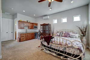 Bedroom with light carpet, a ceiling fan, and recessed lighting
