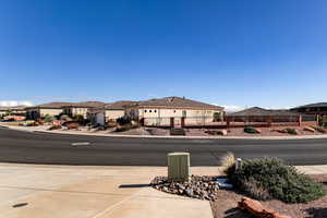 View of asphalt road with sidewalks, a residential view, and curbs