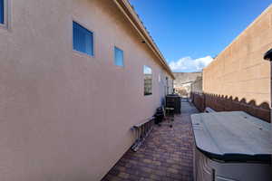 View of side of home featuring stucco siding and a patio