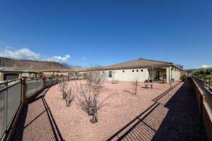 Rear view of property featuring a fenced backyard and a mountain view