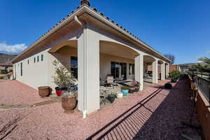 Rear view of house featuring stucco siding and a patio