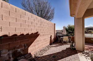 Fenced backyard with outdoor dining space and a patio