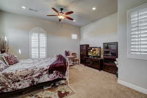 Carpeted bedroom with ceiling fan and recessed lighting