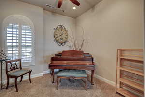 Sitting room featuring a ceiling fan, light carpet, and recessed lighting