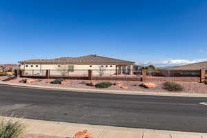 View of front of house featuring a tile roof and stucco siding