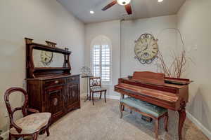 Sitting room featuring light colored carpet, a ceiling fan, and recessed lighting