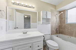 Bathroom with vanity and bathing tub / shower combination