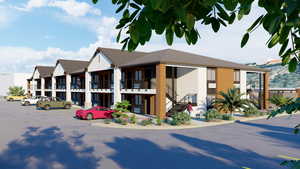 View of property with stairway and uncovered parking