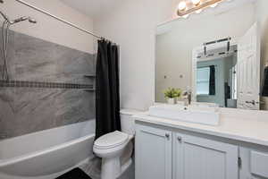 Full bath featuring shower / bath combo and vanity