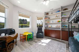 Office area featuring ceiling fan, light wood finished floors, and recessed lighting