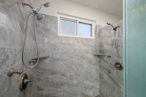 Bathroom featuring a tile shower