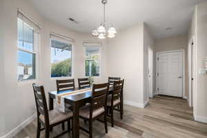 Dining space featuring a chandelier and light wood-style flooring
