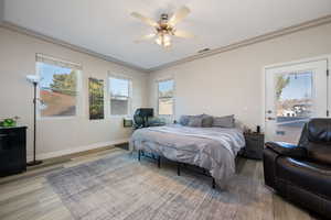 Bedroom featuring access to exterior, wood finished floors, and ceiling fan