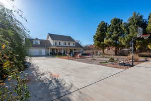 View of front of house featuring driveway and a porch