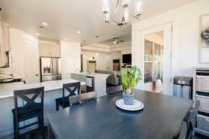 Dining area with a chandelier and ceiling fan