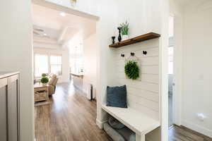 Mudroom featuring dark wood-style floors and a tray ceiling