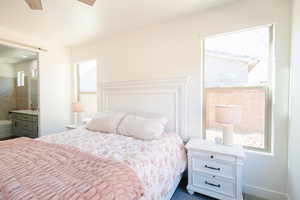 Bedroom with ensuite bath, carpet, and ceiling fan