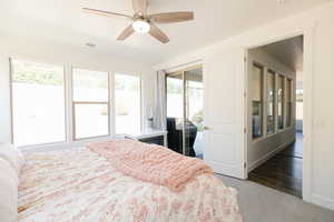 Bedroom featuring dark carpet, access to outside, and ceiling fan