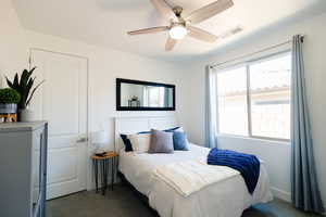Bedroom with dark carpet and ceiling fan