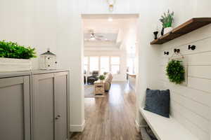 Mudroom with ceiling fan, a tray ceiling, dark wood-type flooring, and recessed lighting