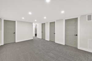Finished below grade area with recessed lighting and carpet flooring