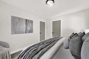Carpeted bedroom featuring baseboards