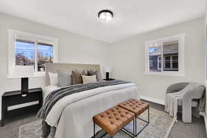 Bedroom featuring carpet flooring and multiple windows