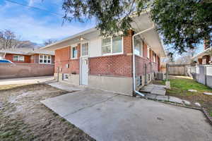 Back of house featuring brick siding