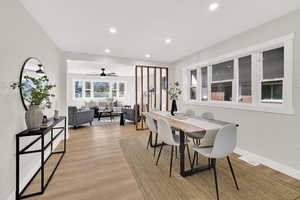 Dining space with light wood finished floors, recessed lighting, and a ceiling fan