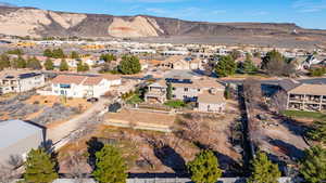 Aerial view of property's location featuring a mountainous background and nearby suburban area