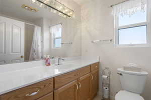 Full bath featuring vanity and a shower with curtain