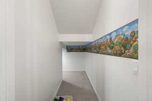 Hall with carpet flooring and baseboards