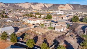 Aerial view of property's location featuring mountains and nearby suburban area