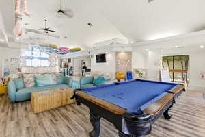 Game room featuring wood finished floors, billiards table, ceiling fan, and lofted ceiling