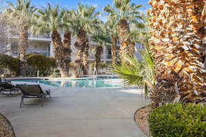 Community pool featuring a patio and a balcony