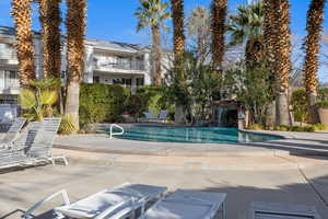 Community pool with a patio