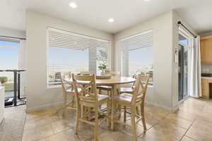 Dining area featuring light tile patterned flooring and recessed lighting
