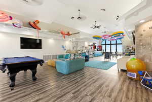 Playroom with a ceiling fan, billiards table, and vaulted ceiling