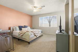 Bedroom with light colored carpet and ceiling fan