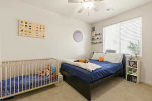 Bedroom featuring light colored carpet and a ceiling fan