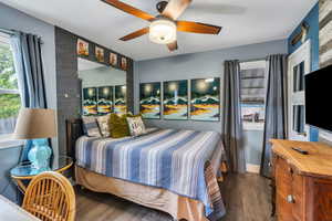 Bedroom with dark wood finished floors and a ceiling fan